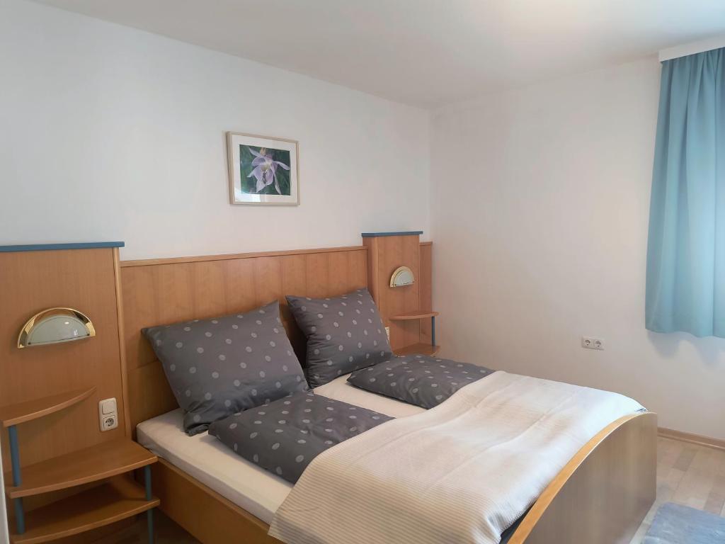 a bed with two pillows on it in a room at Apartment Alpenblick Lienz in Lienz