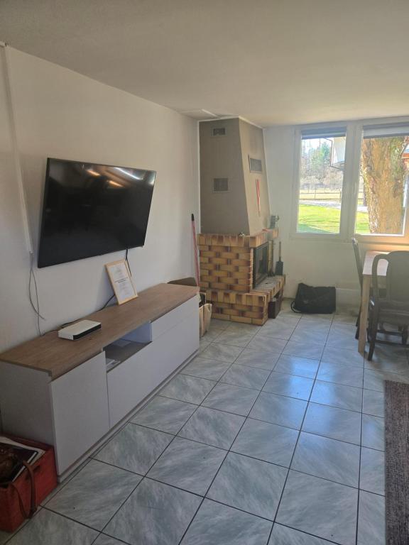 a living room with a flat screen tv on a wall at Domek Beskid Żywiecki in Rycerka Dolna
