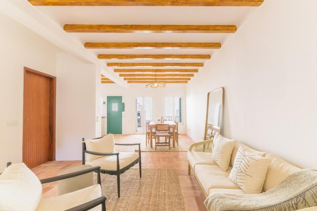 a living room with a couch and chairs and a table at Casa Sol Limão in Zambujeira do Mar