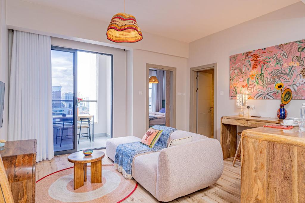 a living room with a couch and a table at Elite One Bedroom Apartment Westlands, Swimming pool, gym, workspace ,Wonderiss Properties close proximity to GTC, JW Mariott and Kempinski in Nairobi