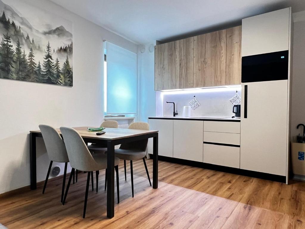 a kitchen and dining room with a table and chairs at Casa Primavera in Agordo