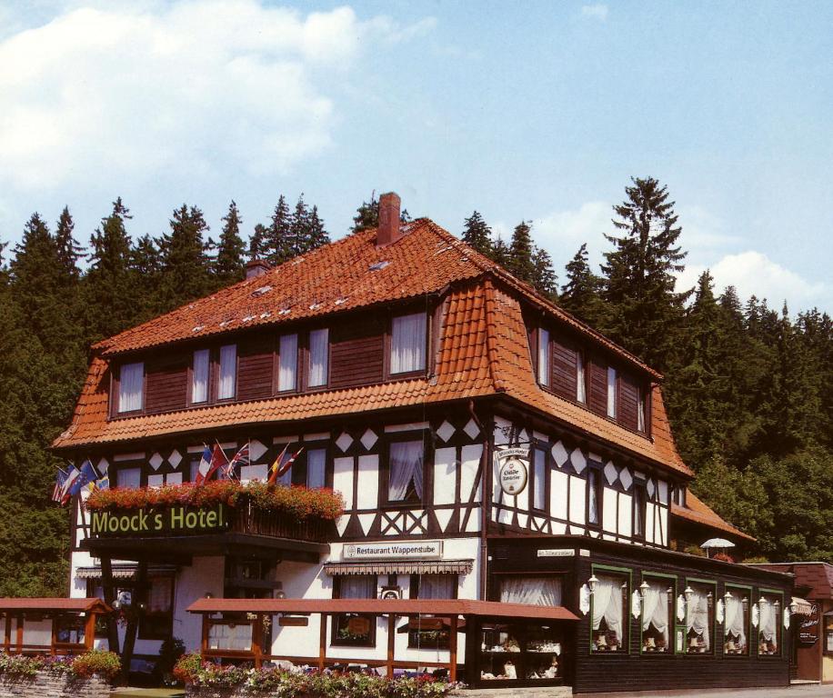 a large building with a red roof at Moocks Hotel in Altenau