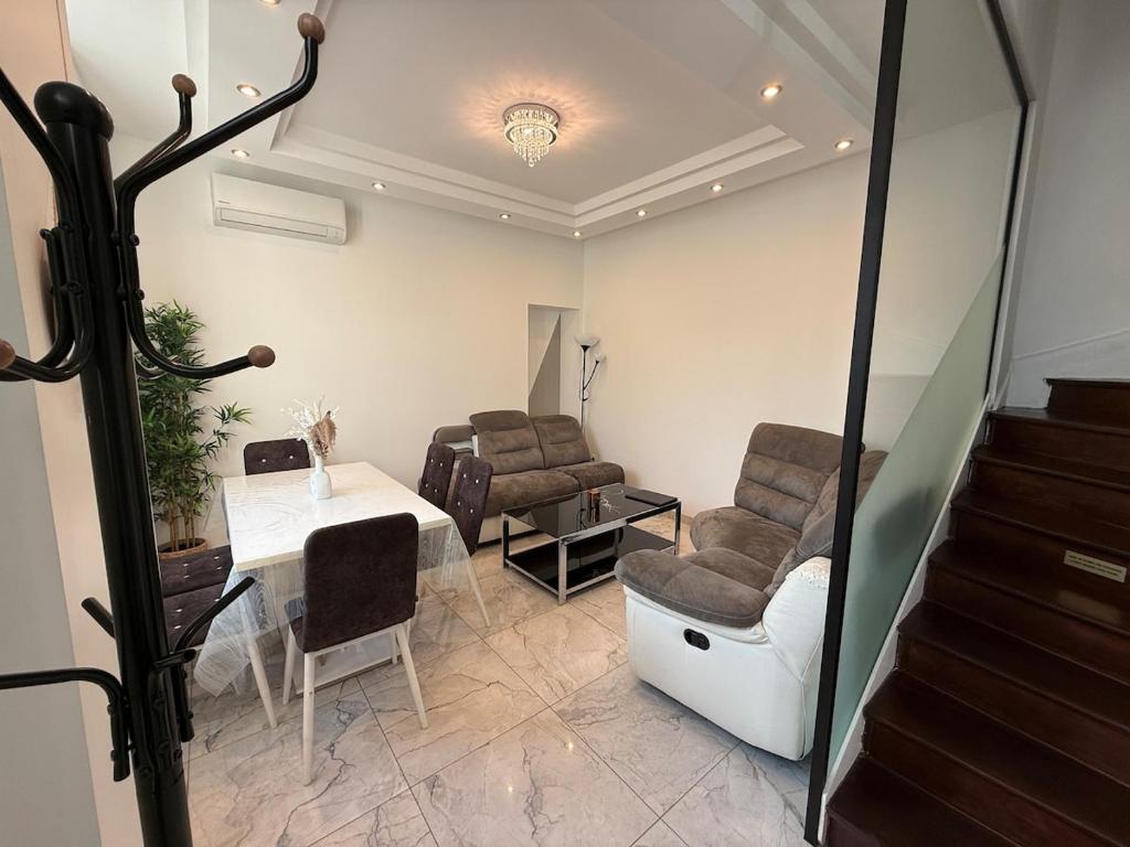 a waiting room with chairs and a table and stairs at Central Grenoble Lovely House in Grenoble