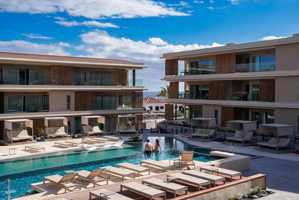 an image of a resort swimming pool with lounge chairs at Kora Tigot in San Miguel de Abona