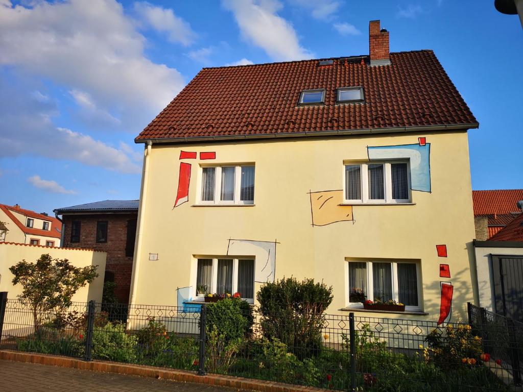 a white house with a red roof at Ferienwohnungen Seewald in Teterow
