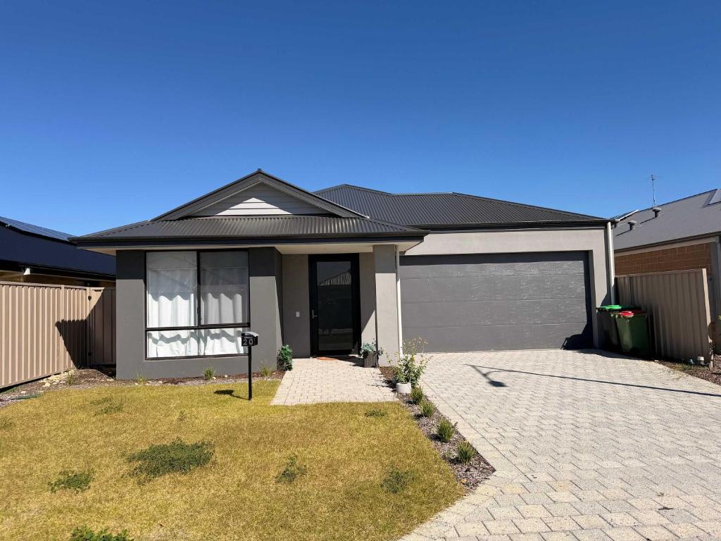a house with a garage and a driveway at Modern Karnup House in Karnup