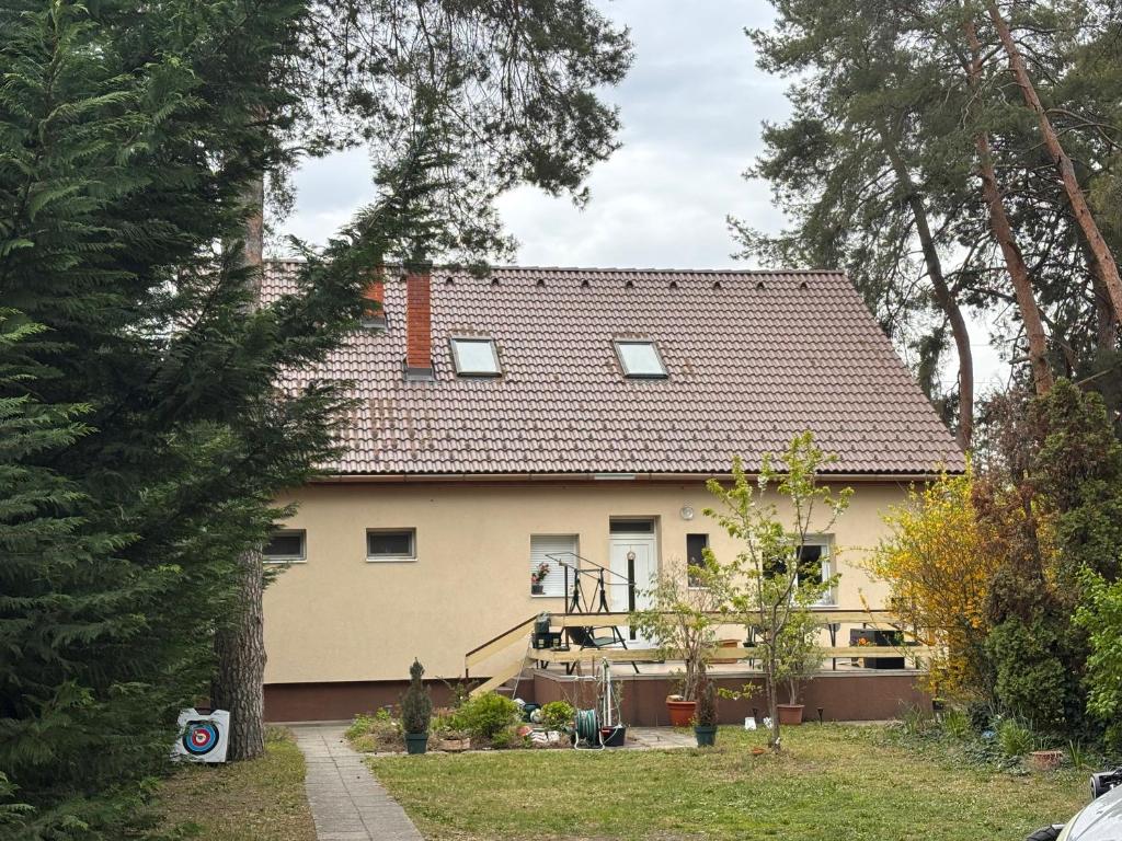 a house with a roof on top of it at Rigó Vendégház in Siófok