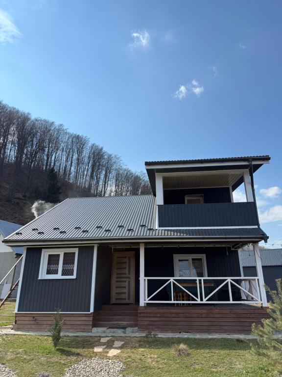 a house with solar panels on its roof at Садиба Смугар in Rostoki