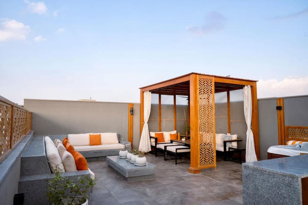 a living room with a couch and a table at VELORA Serviced Rooftop Studio With Private Jacuzzi in Sodic New cairo in New cairo