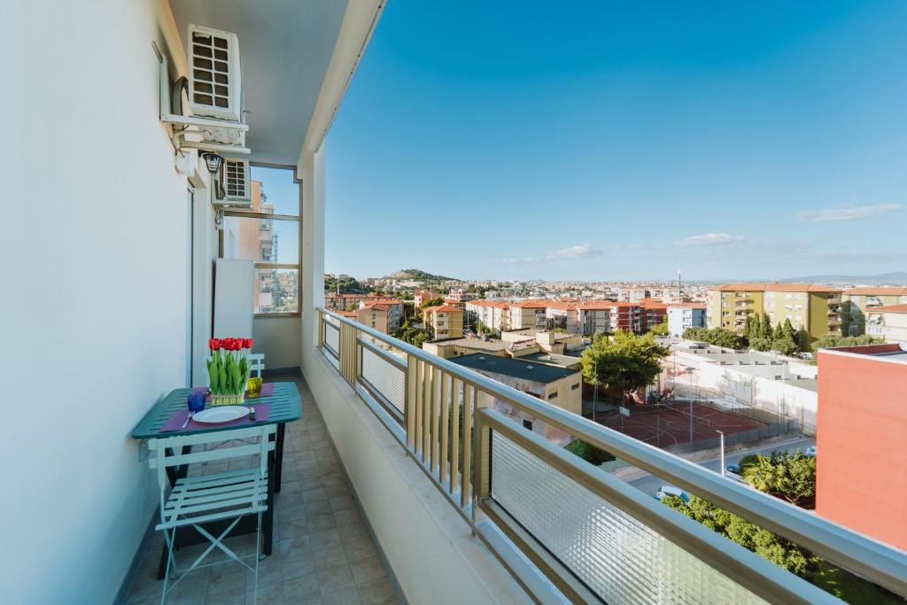 a balcony with a table and a view of the city at 7th Floor - Donoratico in Cagliari