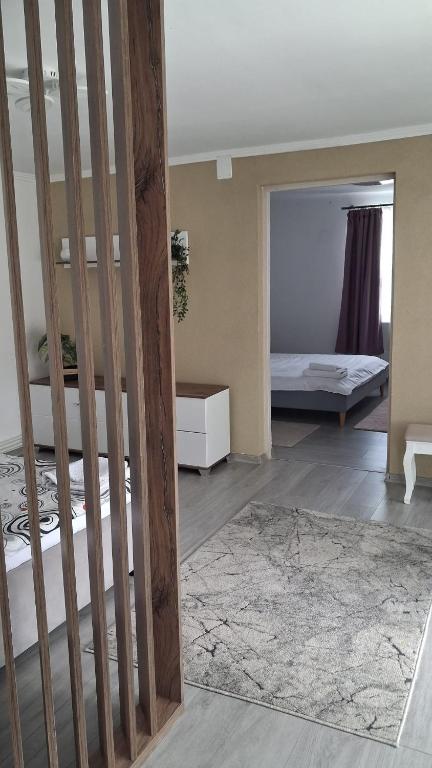 a room with a staircase and a room with two beds at Paul's Houses 2 in Ocna-Mureşului