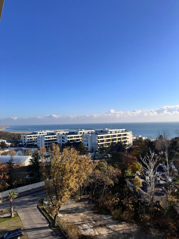 a view of a building with the ocean in the background at VOGH Olimp Premium Sea View Escape in Olimp