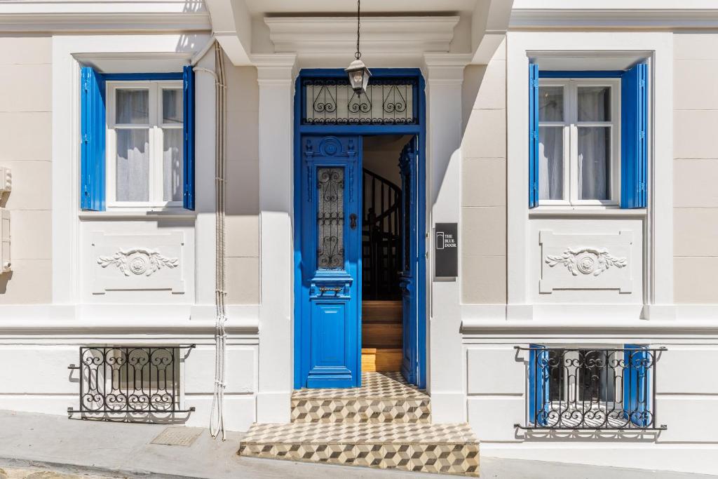 a blue front door of a white house at The Blue Door - Skopelos in Skopelos Town
