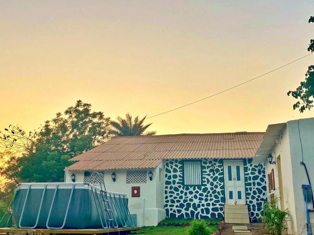 a blue and white house with a fence in front of it at The Coastal Nest in Daman