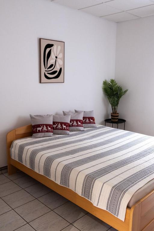 a bedroom with a large bed with red pillows at Apartment Sučany 3 in Sučany