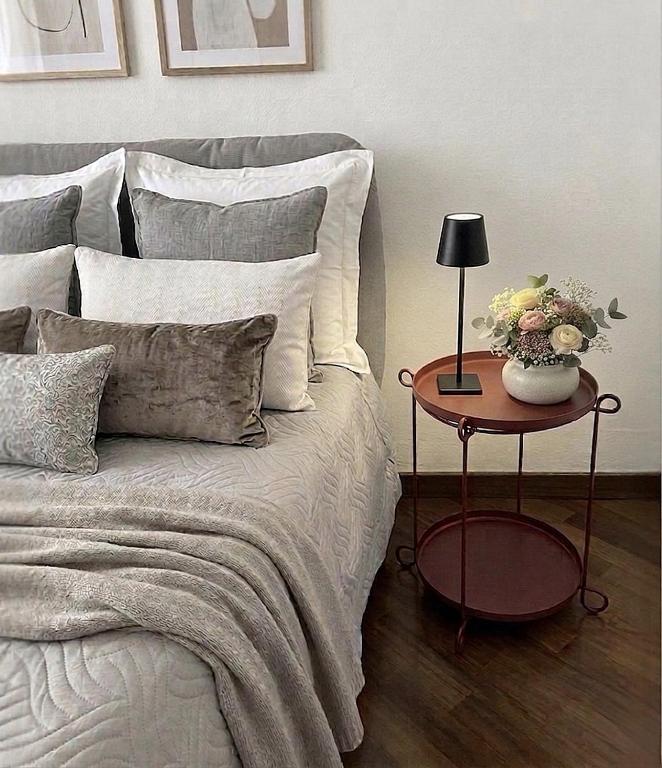 a bedroom with a bed with a table with a lamp at Rossini aptm in Sassoferrato