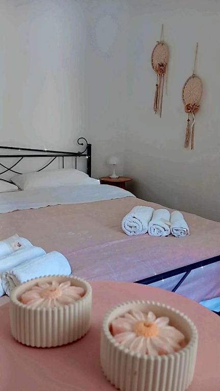 a bedroom with a bed with towels on it at Traditional Grandma's house in Chios