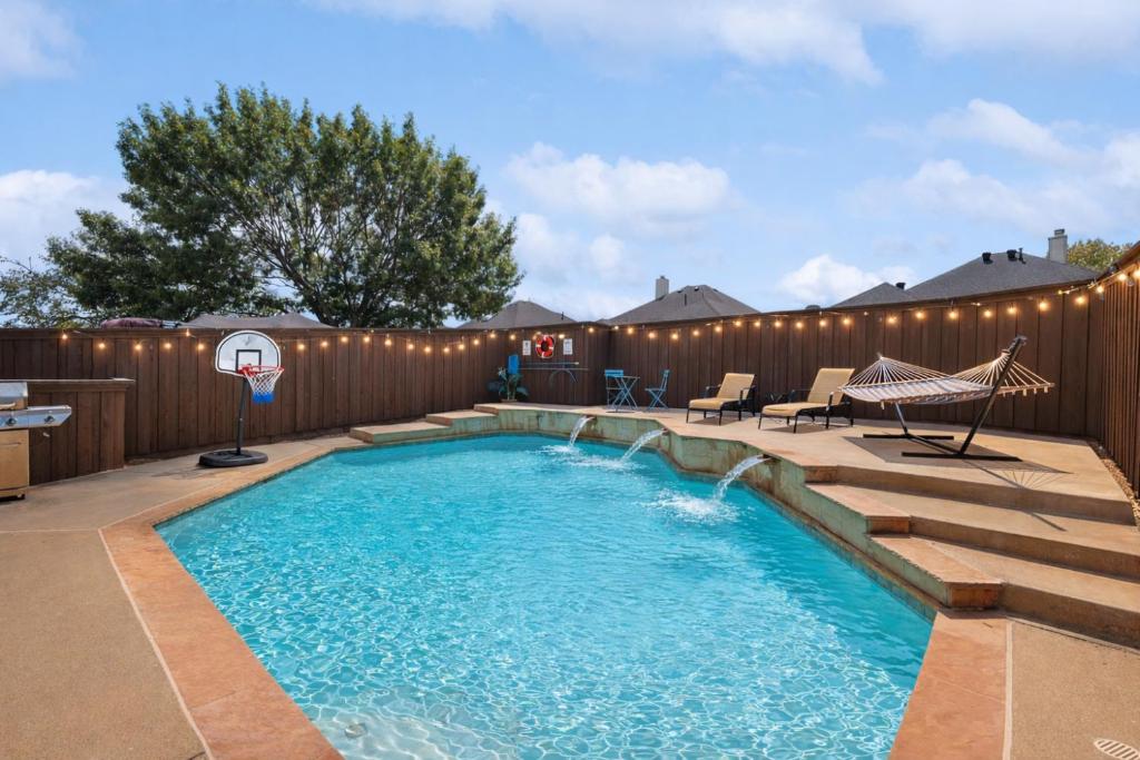 a swimming pool with a patio and a fence at Elegant 5BR Retreat w Private Pool & Game Room in Mesquite