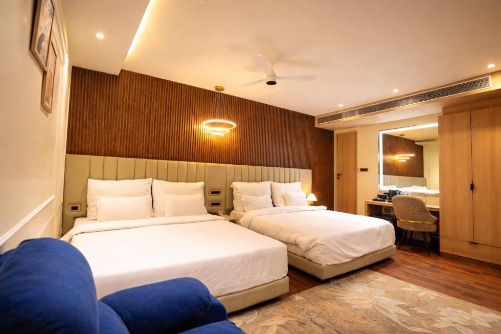 a hotel room with two beds and a desk at THE GRAND SUNCITY HOTEL AND RESORT, Bhopal in Bhopal