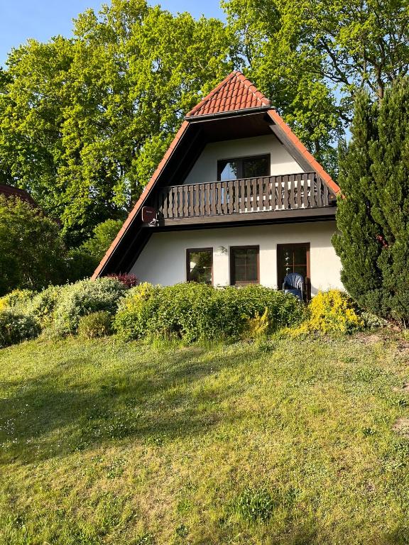 a house with a balcony on top of a hill at Finnhaus Annika in Marlow
