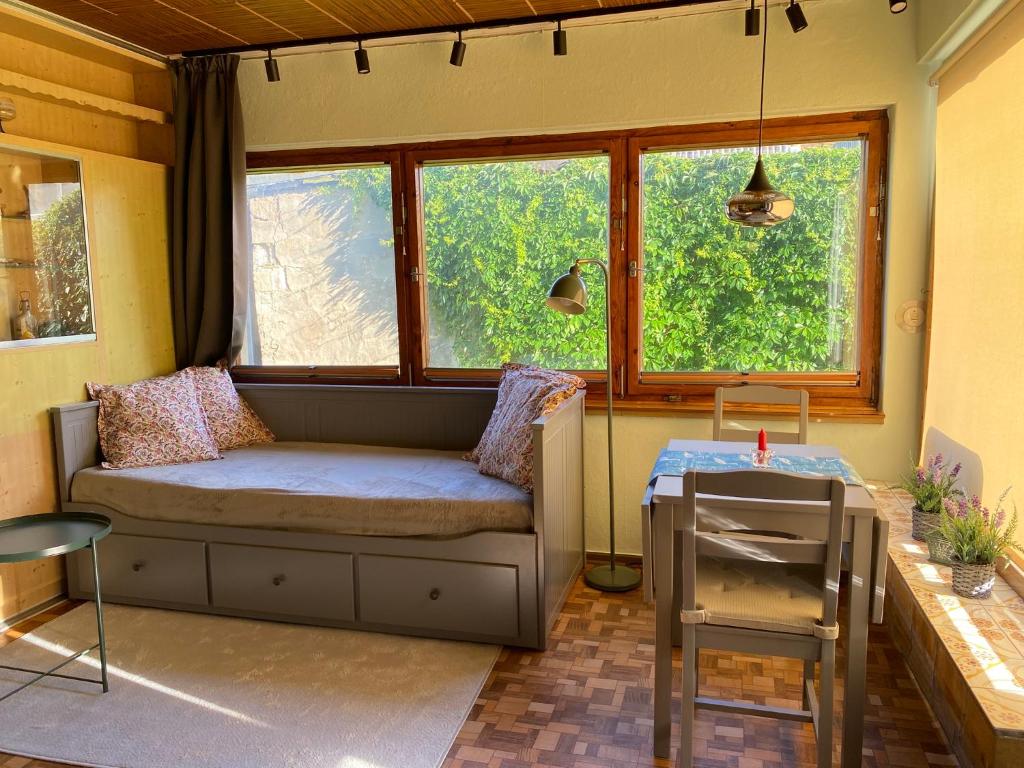 a living room with a couch and two windows at Ferienwohnung Graureiher in Marlow