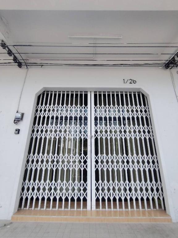 a door with a metal gate in a building at Quiet place with duplex room in Ban Kohong