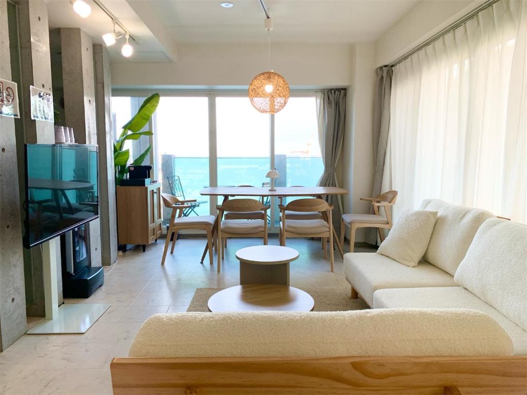 a living room with a couch and a table at O2 capsule house OTARU in Otaru