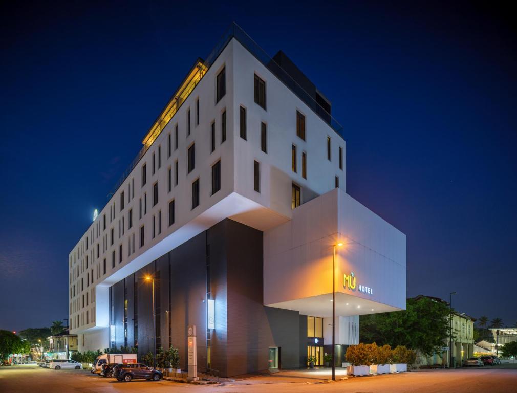 a white building with a crane on top of it at MU Hotel in Ipoh
