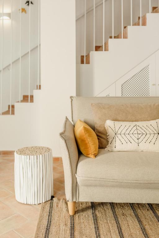 a living room with a couch and a table at Casa do Sol - Casas do Levante in Olhão