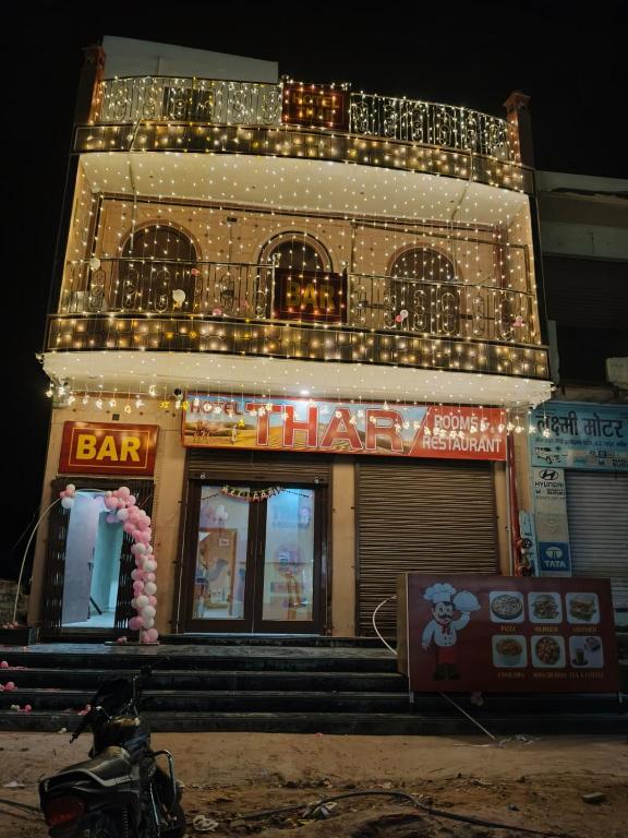 a bar with lights on top of a building at Hotel THAR in Bikaner