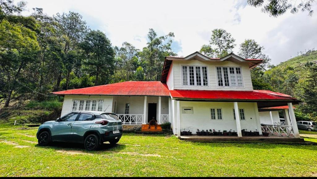 a small house with a car parked in front of it at GP Estate Bungalow in Suryanelli