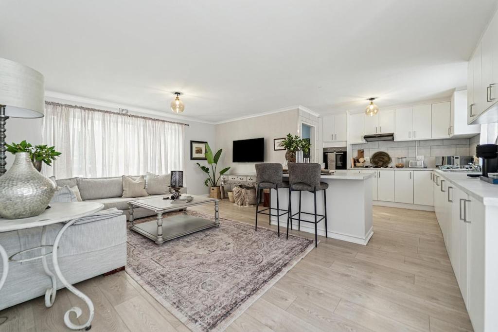 a kitchen and living room with a couch and a table at The Willow Cottage in Oakdale