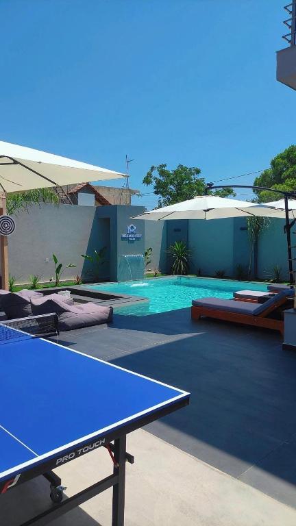 a blue ping pong table on a patio with a pool at Mr & Mrs Grey Villas-Private Pool Luxury in Zakynthos near Laganas in Ambelókipoi