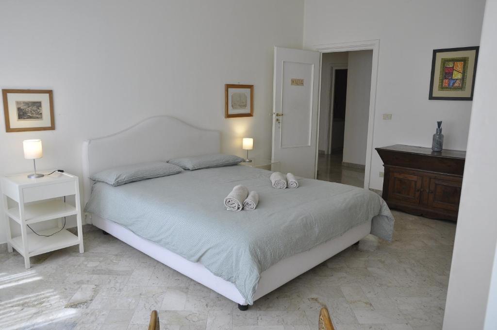 a bedroom with a bed with two towels on it at Piccinni house in Bari