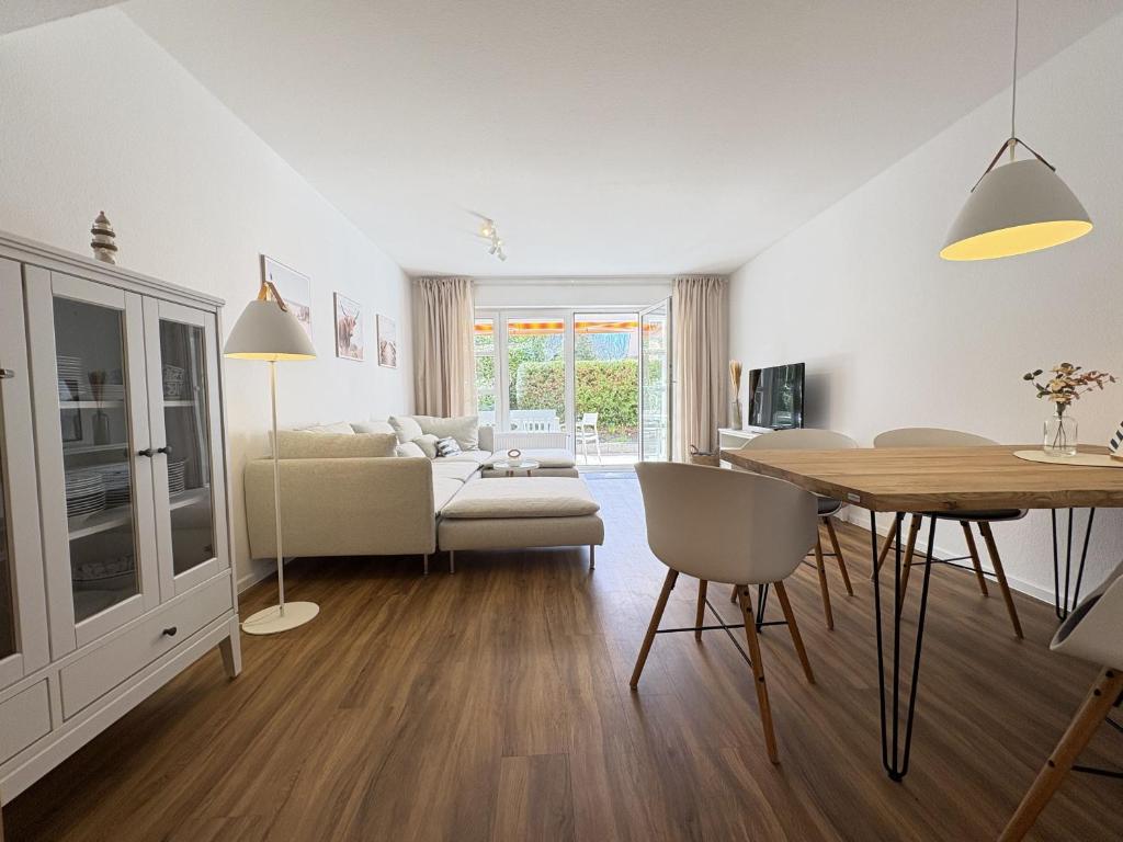 a living room with a table and a dining room at Allee 1G - Meerzeit in Dahme