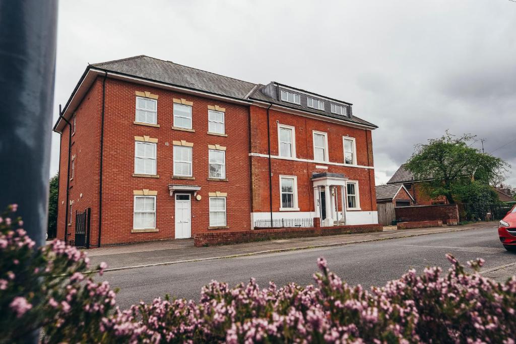 a red brick building on the side of a street at Dalby House in Derby
