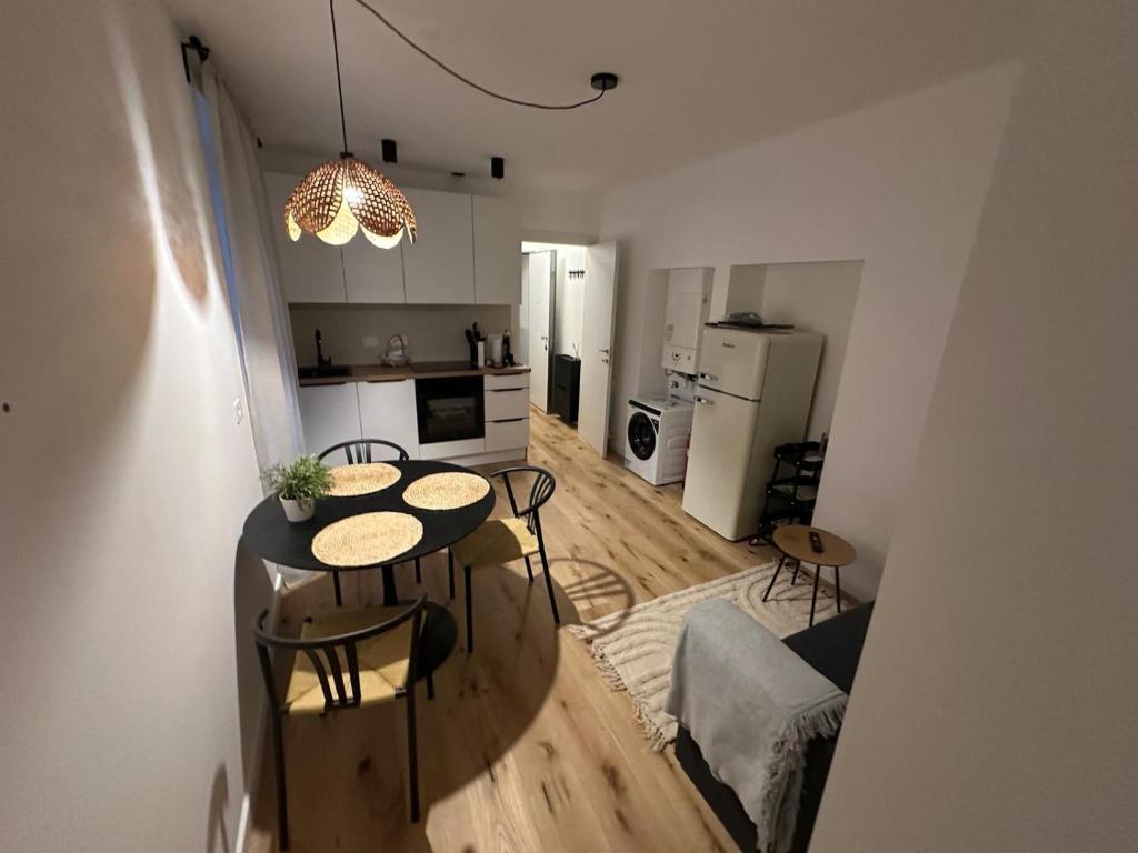 a kitchen and dining room with a table and chairs at 11 Apartaclean Cancellieri in Trieste