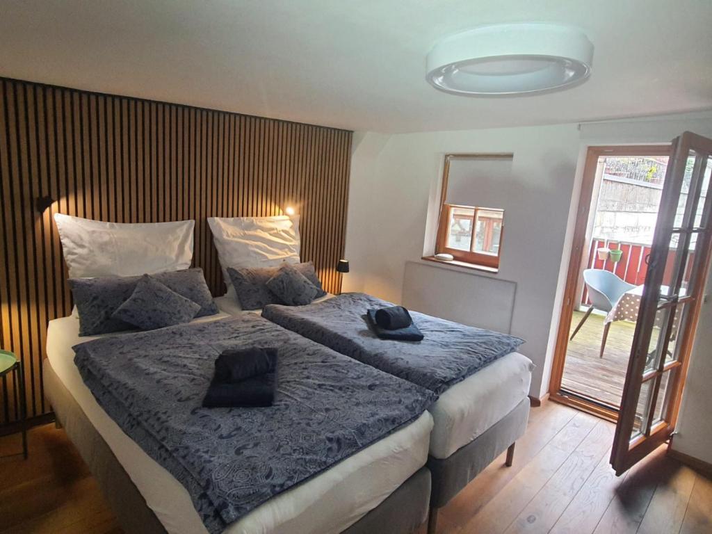a bedroom with a large bed with a blue blanket at FeWo Sonne in Konstanz