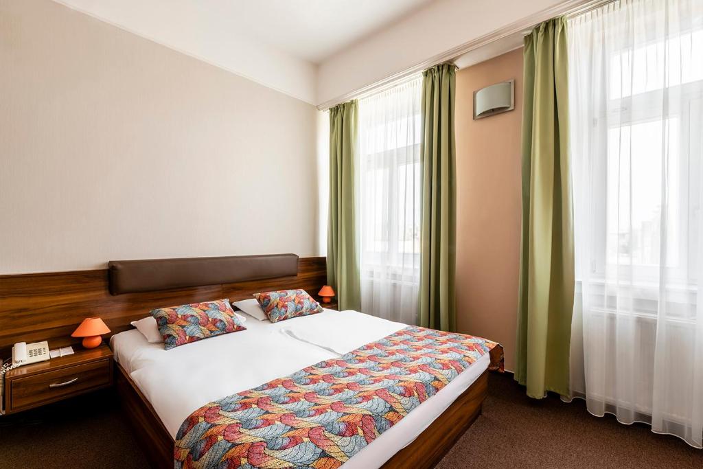 a bedroom with a bed and a large window at Star Hotel by Mellow Mood Hotels in Budapest