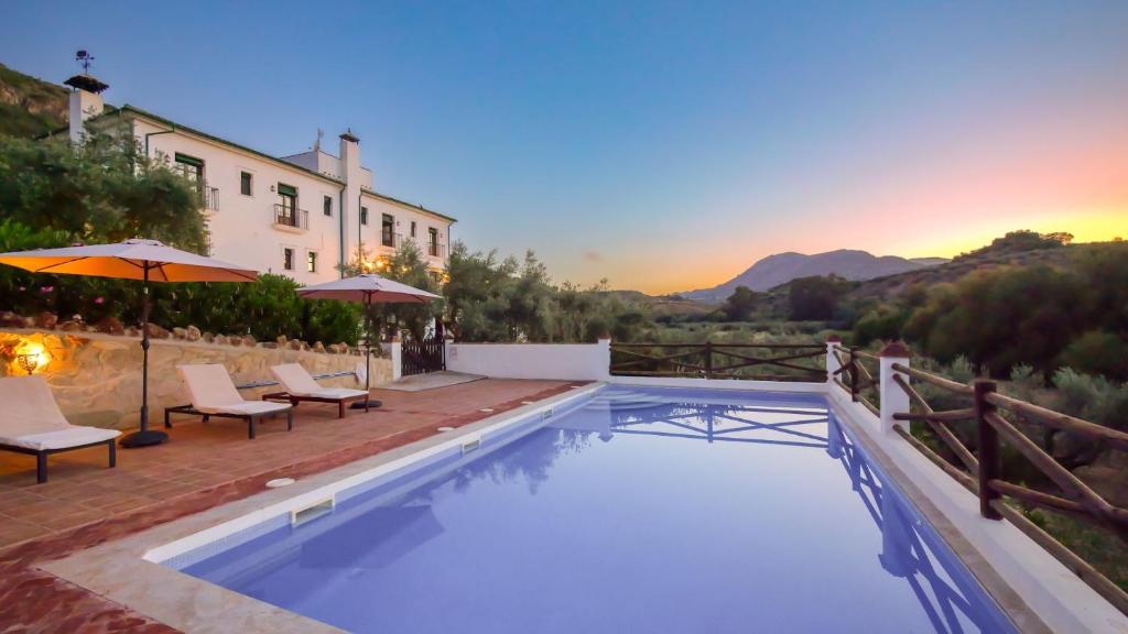 a swimming pool with a view of the mountains at Casa Olea in Priego de Córdoba