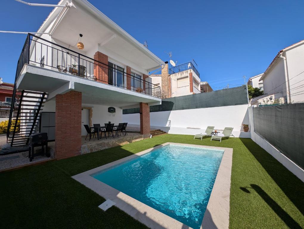 a swimming pool in the backyard of a house at VILLA Pinemar & Relax in Pineda de Mar