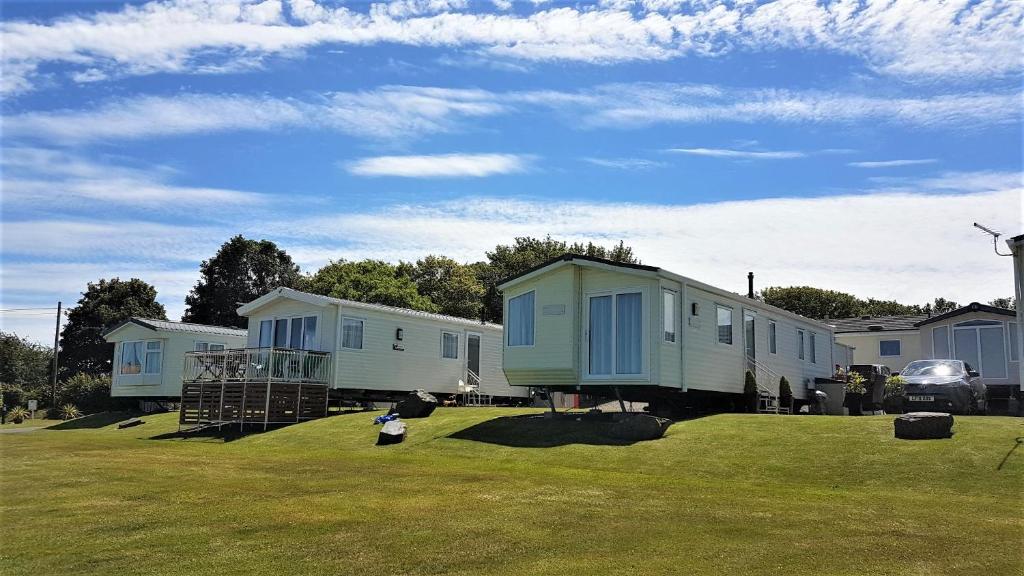 a row of mobile homes in a field of grass at Bardsey View Holiday Park Nr New Quay in Llanarth