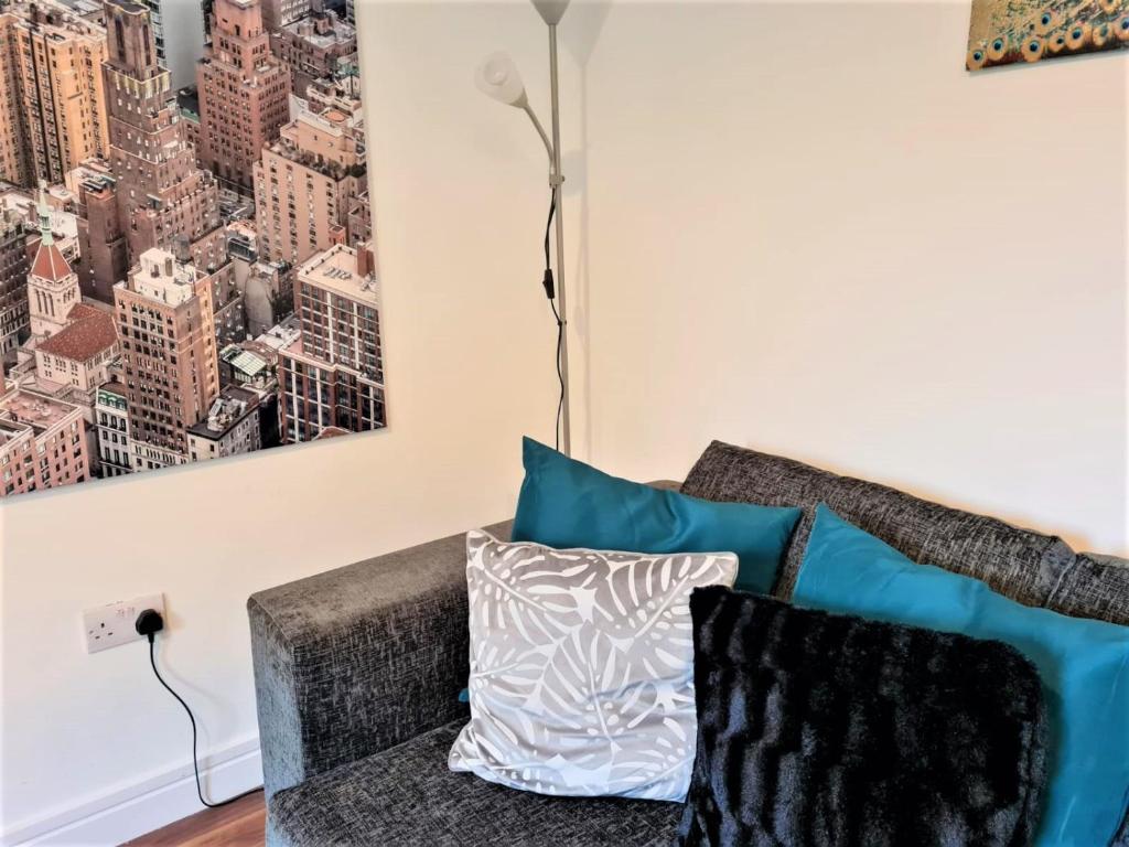 a living room with a couch and a painting on the wall at K Suites - Station Road 2 in Hinckley