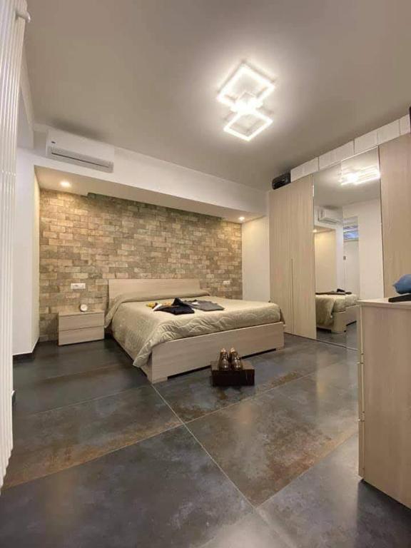 a bedroom with a bed and a brick wall at Risorgimento House in Isernia