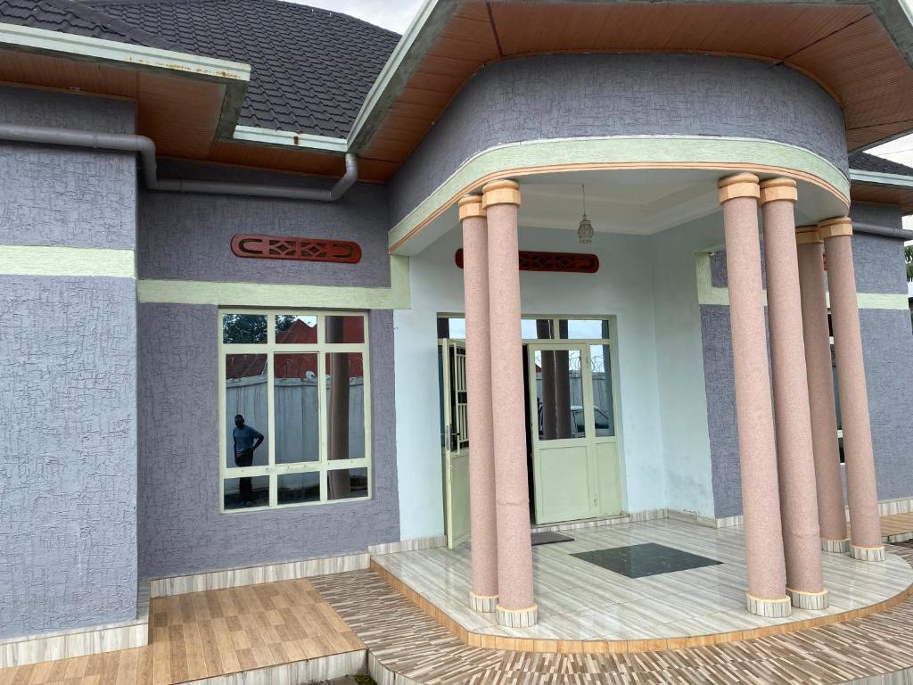 a rendering of a house with columns at B-luxury stay in Ruhengeri