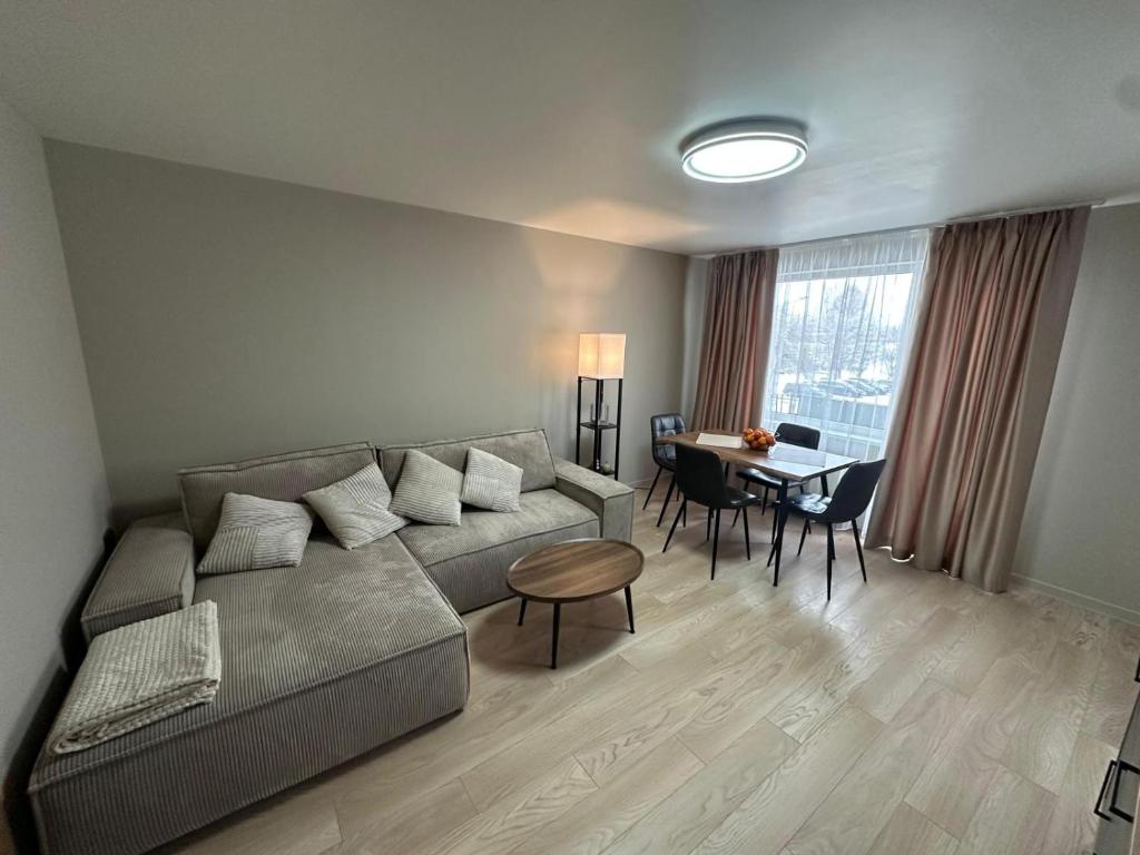 a living room with a couch and a table at MD Apartment in Rēzekne