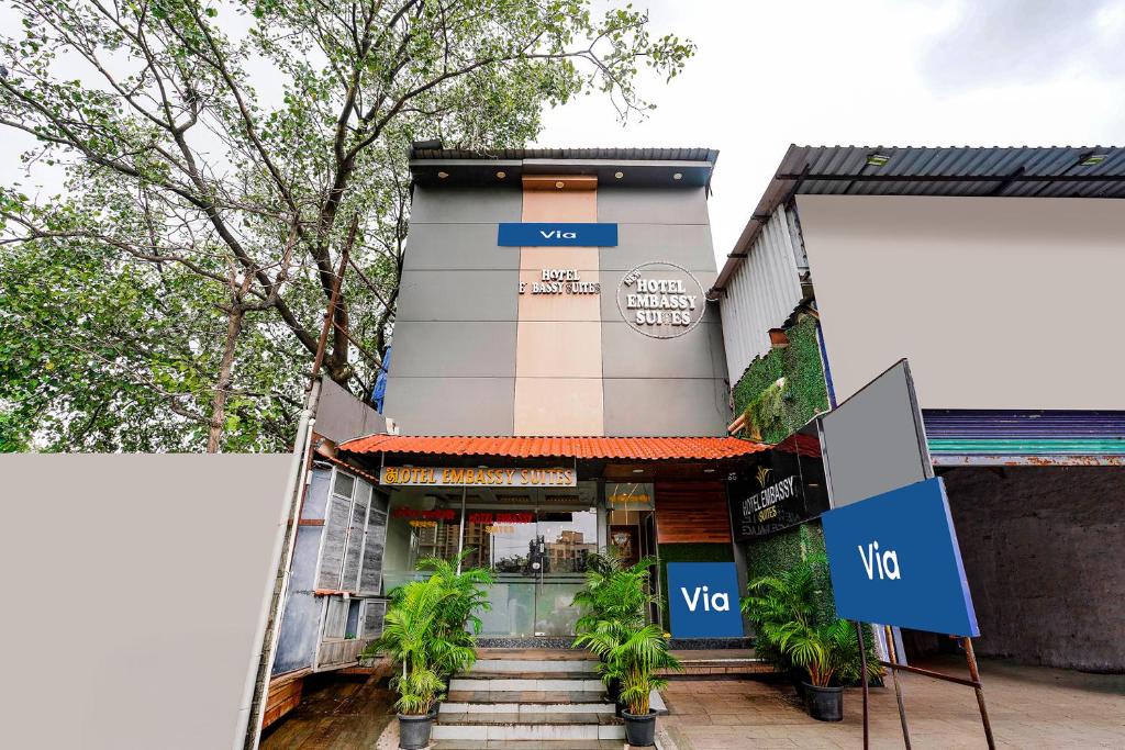a building with a sign in front of it at Via Embassy Suites in Mumbai