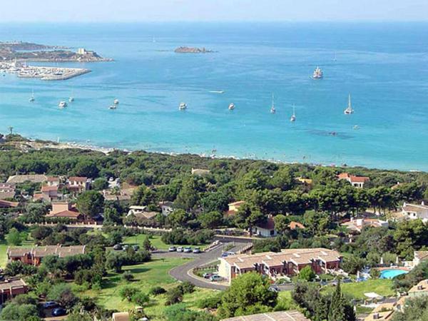 an aerial view of a town with the water and boats at Residence la Chimera in Villasimius