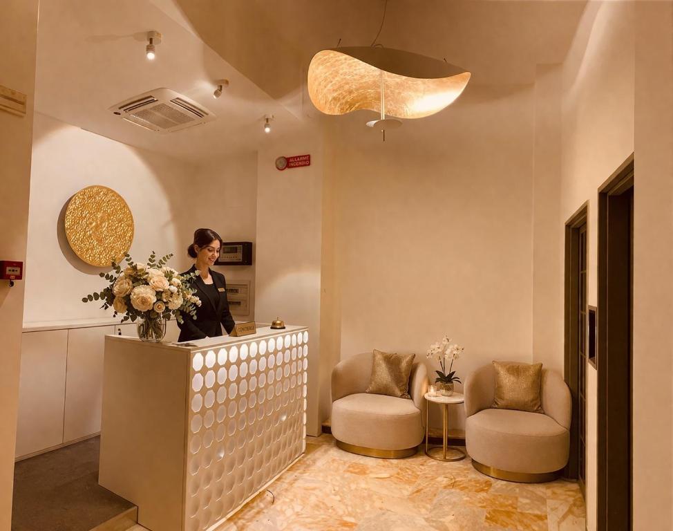 a woman standing at a counter in a salon at Grand Hotel San Lorenzo in Mantova