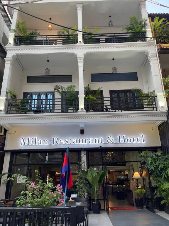 akritkrit restaurant and hotel with a sign in front of a building at Milan Hotel & Restaurant in Phnom Penh